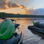 Two jet skis docked at sunset